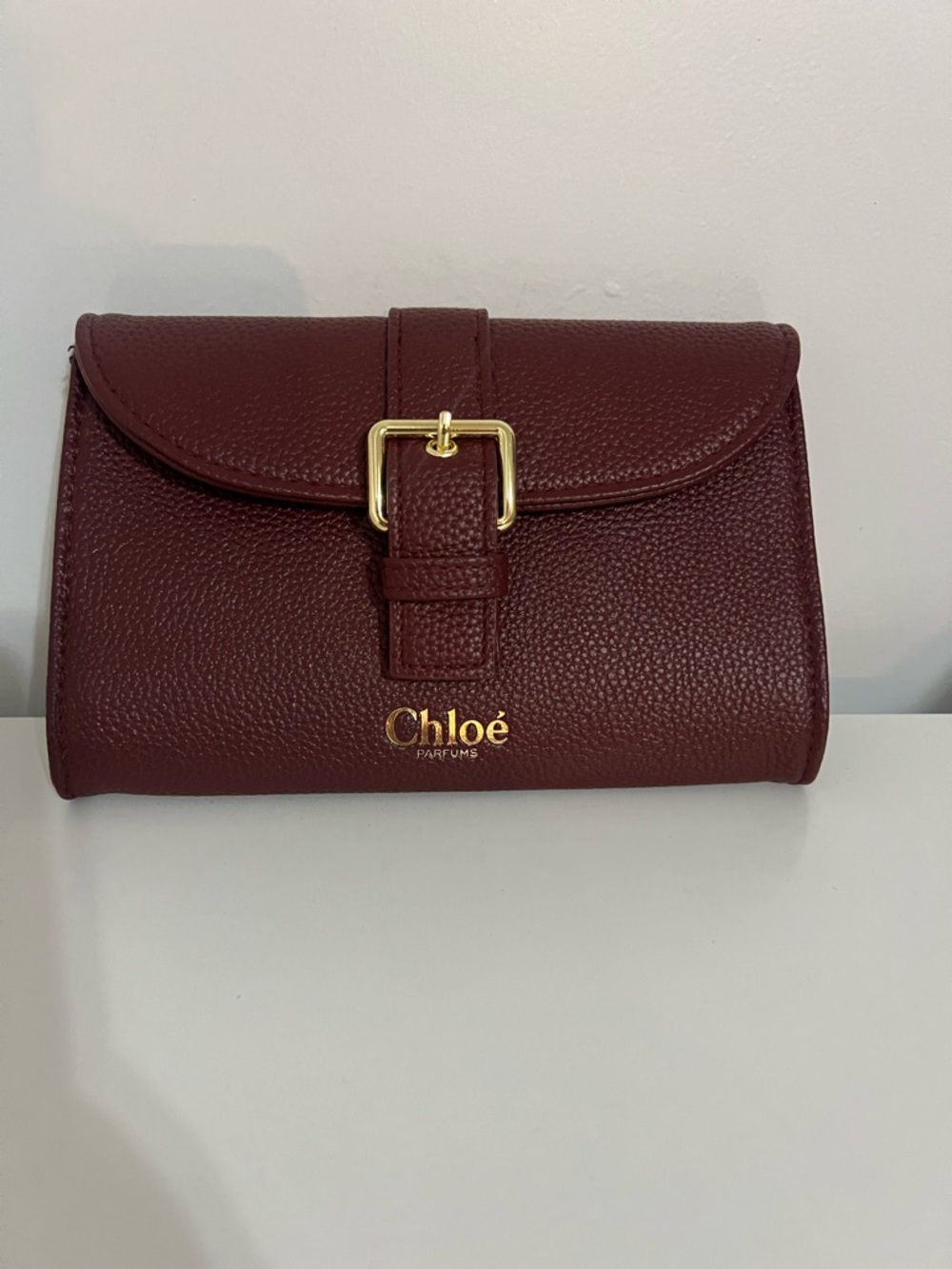 NWOT Chloe Perfumes Burgundy Clutch with Gold Buckle Makeup Bag